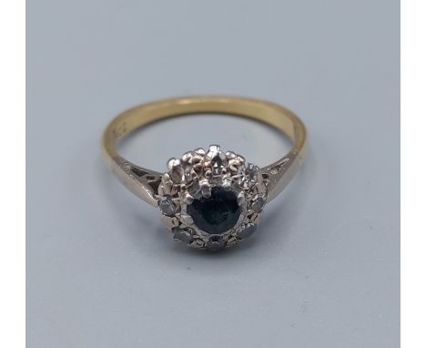 An 18ct gold Sapphire and Diamond cluster ring with a central Sapphire surrounded by Diamonds, 2.7gms, ring size L 