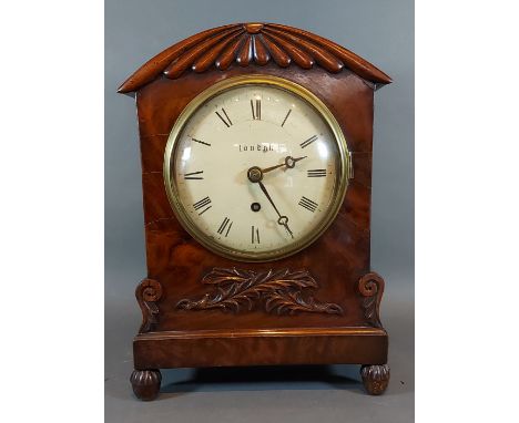 A William IV mahogany cased bracket clock with carved and shaped case,the circular enamel dial inscribed London with Roman nu