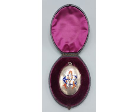 A Victorian silver oval large locket enamel decorated with initials within in fitted lined case 