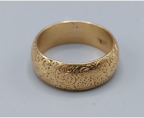 An 18ct gold engraved wedding band, 7.9gms, ring size N 