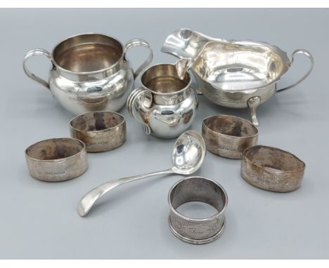 A Birmingham silver two handled sucrier, a similar Chester silver cream jug, a set of four Sheffield silver napkin rings, a S