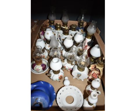 A large collection of assorted miniature ceramic oil lanterns etc.
