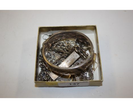 A box of silver and white metal jewellery to include a foliate engrave bangle, and ID bracelet etc. 