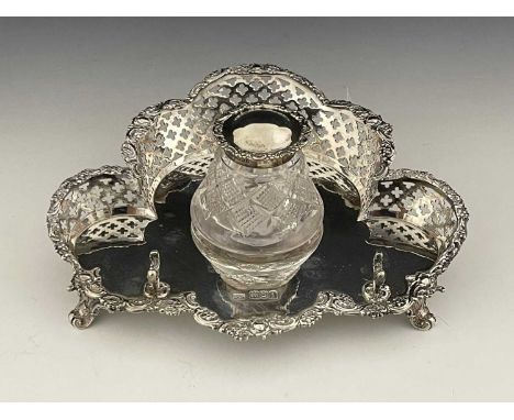 An Edwardian silver inkstand, of trefoil form, with a raised pierced gallery border with floral and foliate scroll capping, w