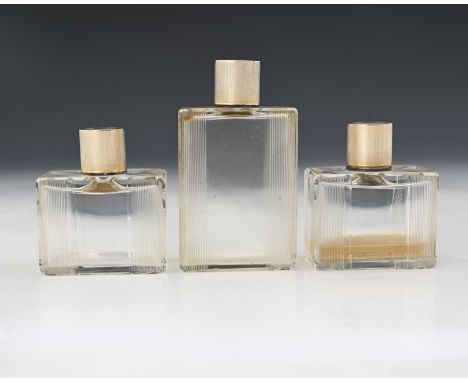 France.Three twentieth-century French first-standard (0.950) silver-mounted glass toilet bottles, each of rectangular form wi