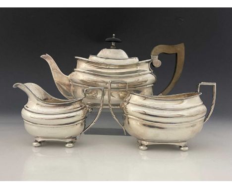 A George V English provincial silver three-piece tea set, comprising teapot, two-handled sugar bowl and milk jug, each of ovo