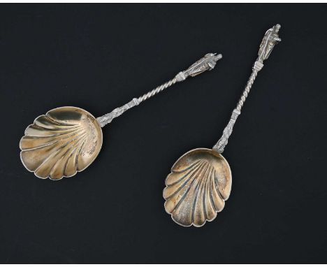 Two Victorian silver gilt serving spoons, each with shell-form bowl, with cast twist stem and apostle-type finial, Martin, Ha