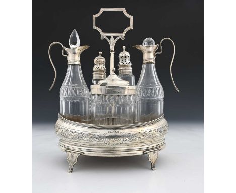 A George III silver five-bottle cruet stand, the base of navette form, decorated with wriggle-work and central band of floral