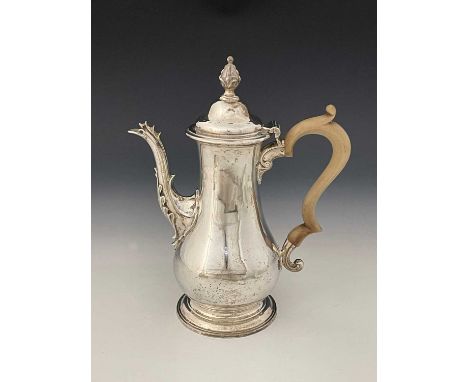 A George III silver coffee pot, of baluster form, atop a stepped and spreading circular form foot, the cast spout capped with