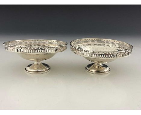 A pair of George V Art Deco style silver bon bon dishes, each of pedestal form with fluted body and pierced gallery border, M