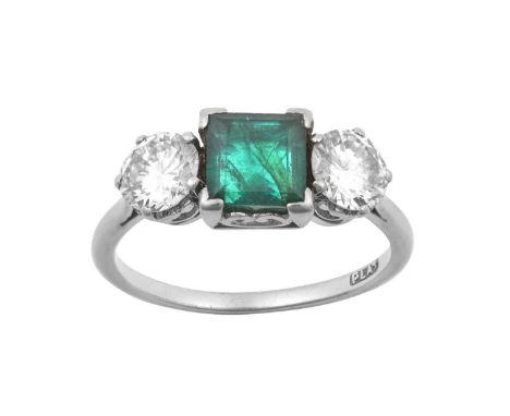 An Emerald and Diamond Three Stone Ringthe square step-cut emerald flanked by round brilliant cut diamonds, in white claw set