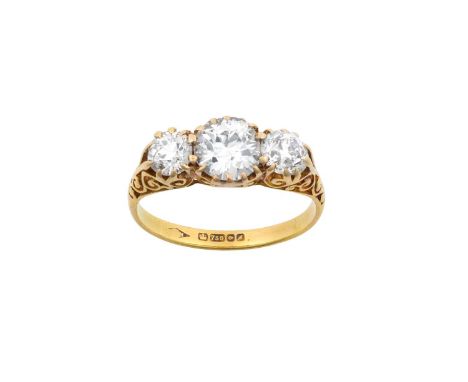 An 18 Carat Gold Diamond Three Stone Ringthe graduated old cut diamonds in yellow claw settings, with a carved gallery and sh