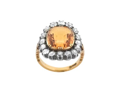 A 19th Century Topaz and Diamond Cluster Ringthe cushion cut orange topaz in a yellow double claw setting, within a border of