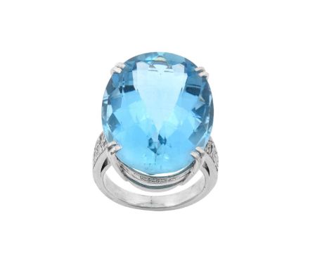 An 18 Carat White Gold Aquamarine and Diamond Ring, by Geoffrey Rowlandsonthe oval fancy cut aquamarine in a double claw sett