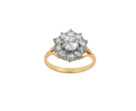 A Diamond Cluster Ringthe round brilliant cut diamond within a border of old cut diamonds, in white claw settings, to a yello