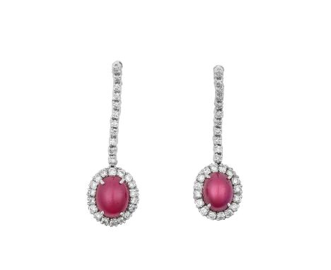 A Pair of 18 Carat White Gold Ruby and Diamond Drop Earringsa row of round brilliant cut diamonds suspend an oval cabochon ru