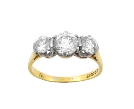 An 18 Carat Gold Diamond Three Stone Ringthe graduated round brilliant cut diamonds in white claw settings, to a yellow taper