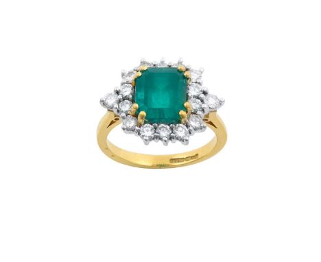 An 18 Carat Gold Emerald and Diamond Cluster Ringthe square emerald-cut emerald in a yellow double claw setting, within a bor