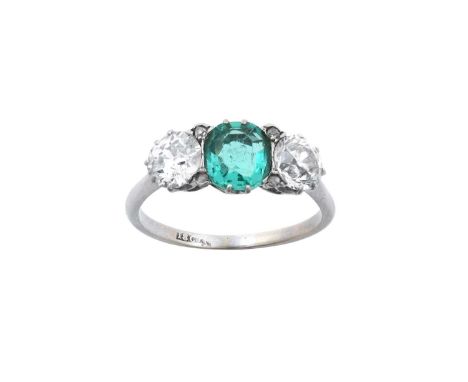 An Emerald and Diamond Three Stone Ring the octagonal cut emerald flanked by old cut diamonds, with rose cut diamond accents,