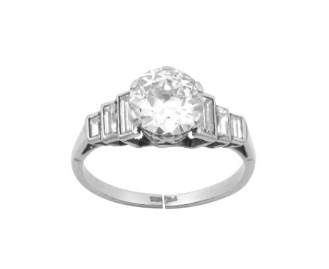 An Early 20th Century Diamond Ringthe old cut diamond in a white six claw setting, with trios of graduated baguette cut diamo