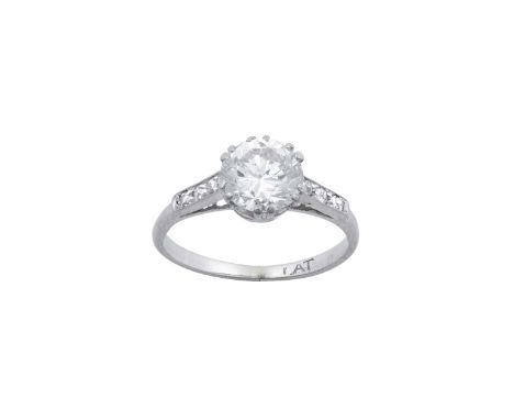 A Diamond Solitaire Ringthe round brilliant cut diamond in a white double claw setting, to eight-cut diamond set shoulders, o