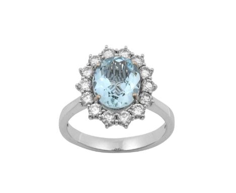 An 18 Carat White Gold Aquamarine and Diamond Cluster Ringthe oval cut aquamarine within a border of round brilliant cut diam