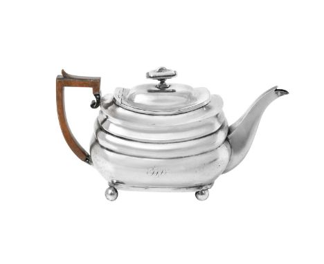A George III Silver Teapot,  by Samuel Wheatley and John Evans, London, 1810 oblong and on four ball feet, one side engraved 