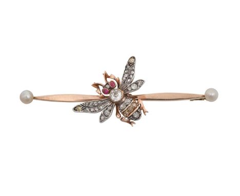 An Early 20th Century Diamond Bee Brooch the bee set with vari-hued shades of old cut diamonds, and ruby eyes, atop a double 