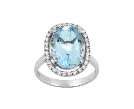 An 18 Carat White Gold Aquamarine and Diamond Cluster Ringthe oval cut aquamarine within a spaced border of round brilliant c