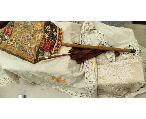 An embroidered table cloth, a backcut lace table cloth, other table covers; a wooden parasol and stick 