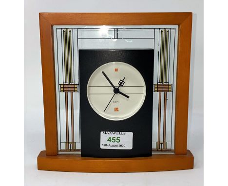 A modern mantel clock by Bulova in wood and glass frame 