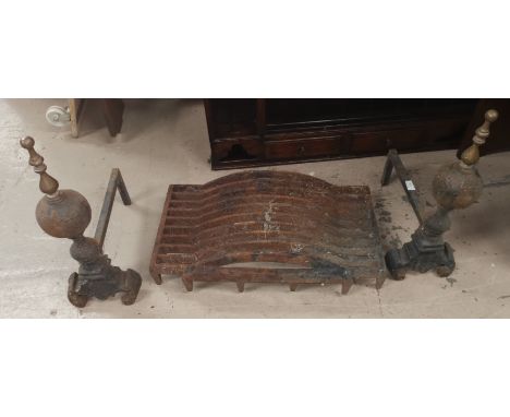 A pair of cast iron and brass fire dogs and dog grate 