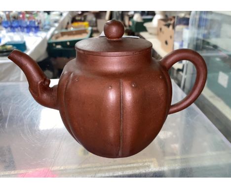 A Chinese Yixing terracotta stone ware teapot of ribbed spherical form impressed square seal mark to base, ;length 19cm