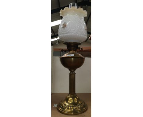 A reproduction brass oil lamp with shade; a brass jam pan; a pair of open barley twist candlesticks; brassware 