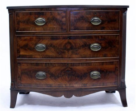 A BOW FRONTED MAHOGANY CHEST OF TWO SHORT AND TWO LONG DRAWERS with fluted canted corners and standing of outswept bracket fe