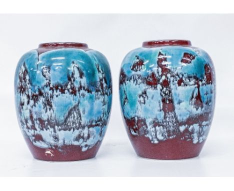 A PAIR OF 1970'S POOLE POTTERY VASES of ovoid form, with mottled blue and dark red glazes, 21.5cm high (2)