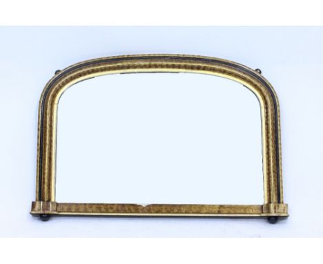 A VICTORIAN OVERMANTLE MIRROR with arching top and scumble decoration to the moulded frame, 89cm wide x 60cm high