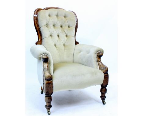 A VICTORIAN ARMCHAIR with button upholstered back and arms and carved front legs, 76cm wide 