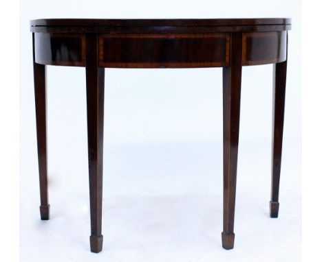 A GEORGE III MAHOGANY AND SATINWOOD CROSS BANDED HALF MOON CARD TABLE with radiating veneers and baize top, on square taperin