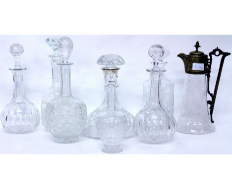 A CUT GLASS SHIP'S DECANTER with a silver collar, six further glass decanters and a claret jug with an etched butterfly and f