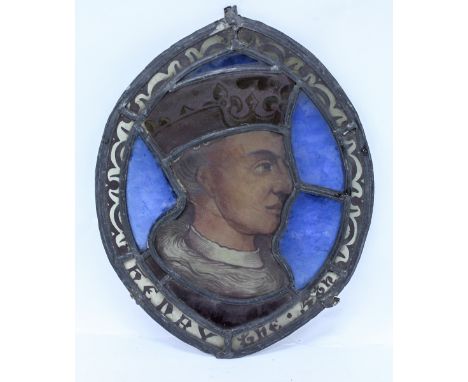 A STAINED GLASS OVAL PANEL depicting a head and shoulder portrait of King Henry V, 33cm in height x 25cm wide