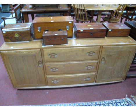 Ercol Light Ash/Elm Sideboard, with end cupboards flanking three drawers, rounded corners, on castors, 155.5cm wide.