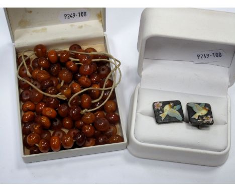 An Amber Colour Bead Necklet (string broken) and a pair of vintage rectangular enamel screw back earrings, depicting bird in 