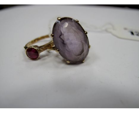 A Single Stone Ring, circular collet set between textured shoulders; A Large Single Stone Ring, oval eight claw set, stamped 