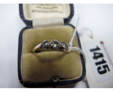 A Three Stone Diamond Ring, graduated claw set, stamped "18ctPLAT".