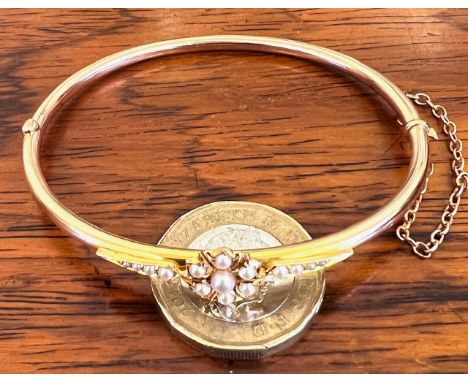 15ct GOLD BANGLE SET WITH FLORAL DESIGN SEED PEARLS AND SAFETY CHAIN, WEIGHT APPROX 6.9g