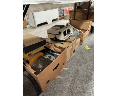 An 8mm Cinefilm projector with some films &amp; 3 slide projectors with accessories