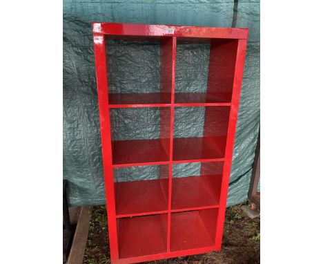 A red gloss effect 8 compartment shelf unit approximately 145 x 80w x 40d cm