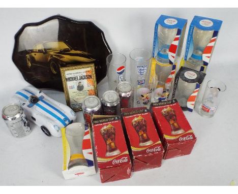 A collection of Pepsi and Coca Cola branded glasses, a framed Michael Jackson 1988 ticket stub for the Bad tour concert at Ai