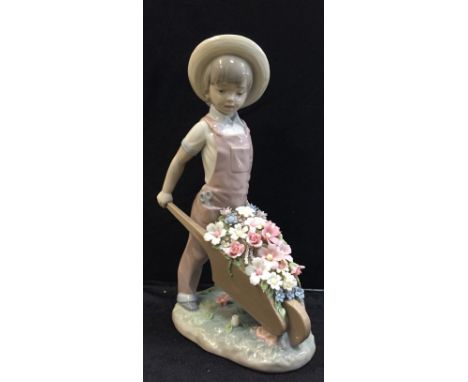 A Lladro girl with wheelbarrow and flowers